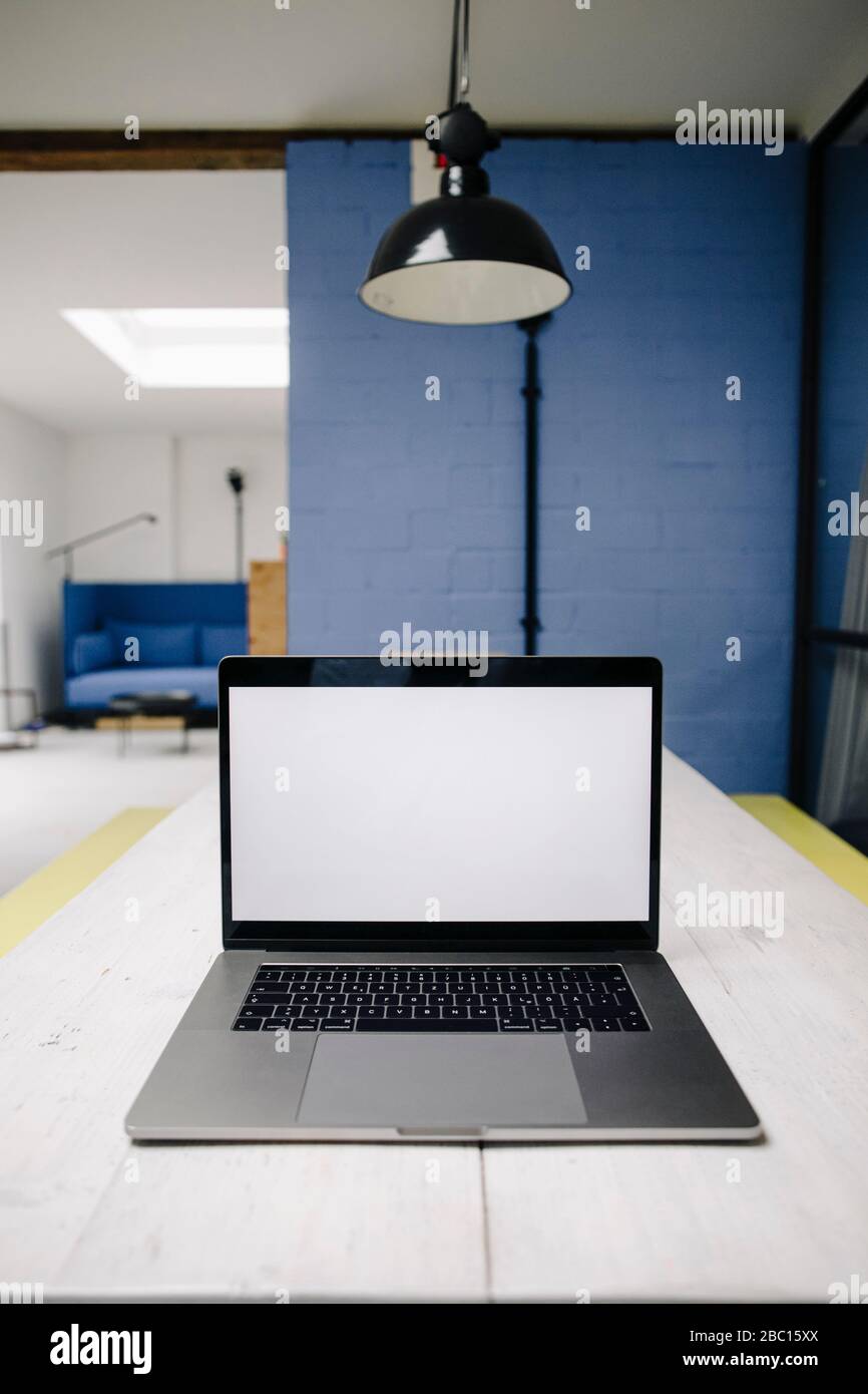 Laptop on table in loft office Stock Photo