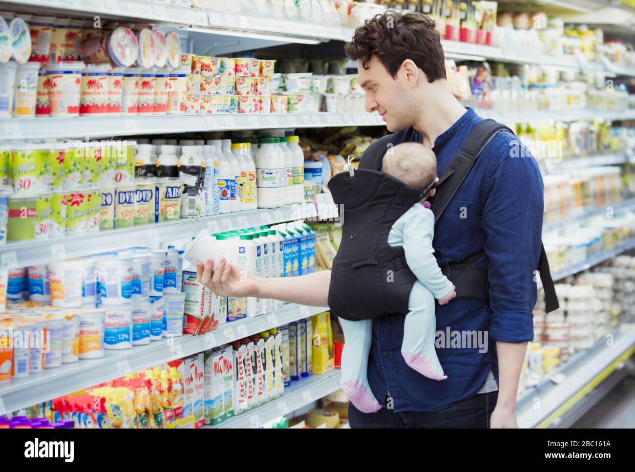 Father with baby daughter shopping in supermarket Stock Photo