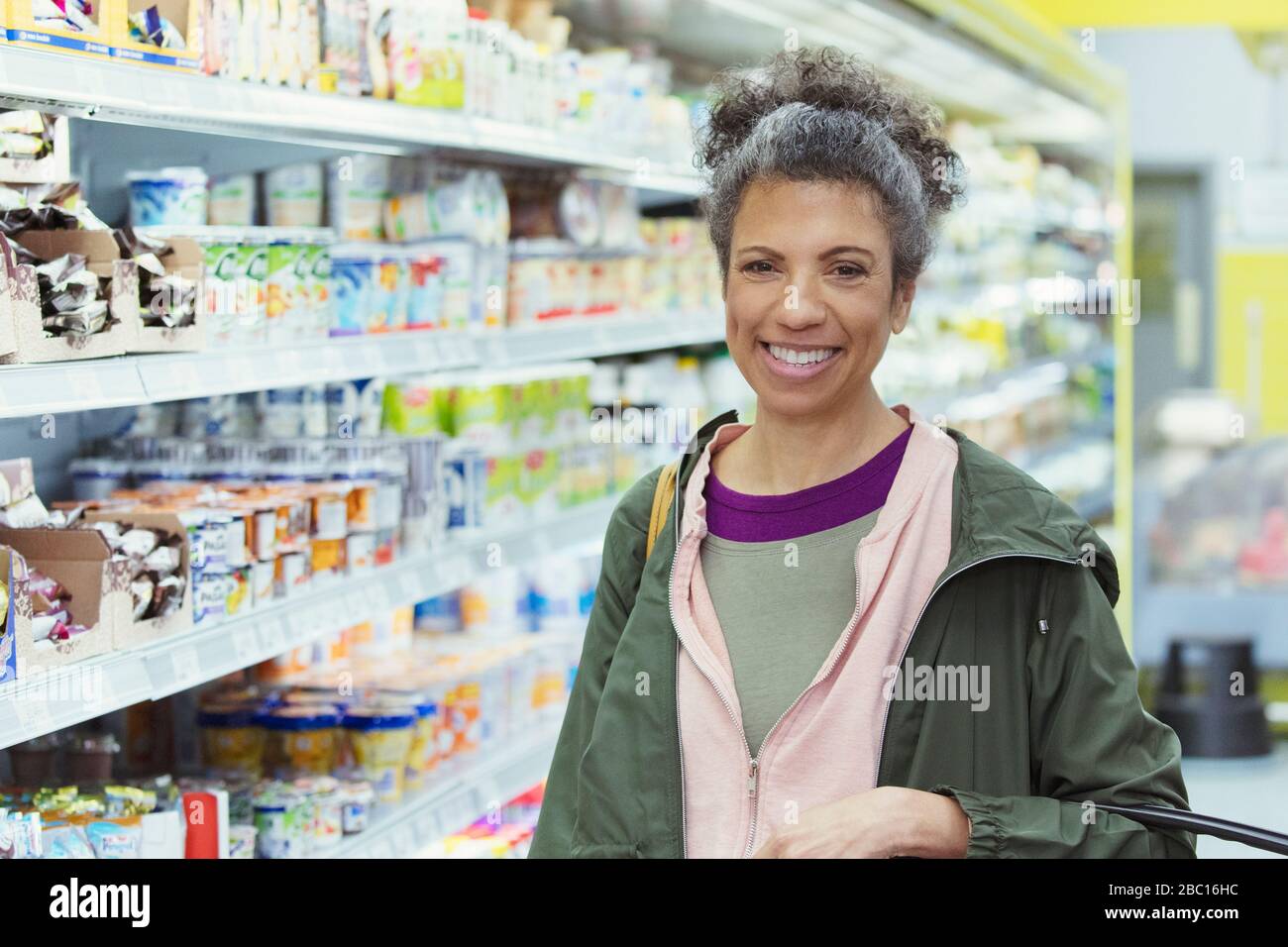 Portrait smiling, confident woman shopping in supermarket Stock Photo