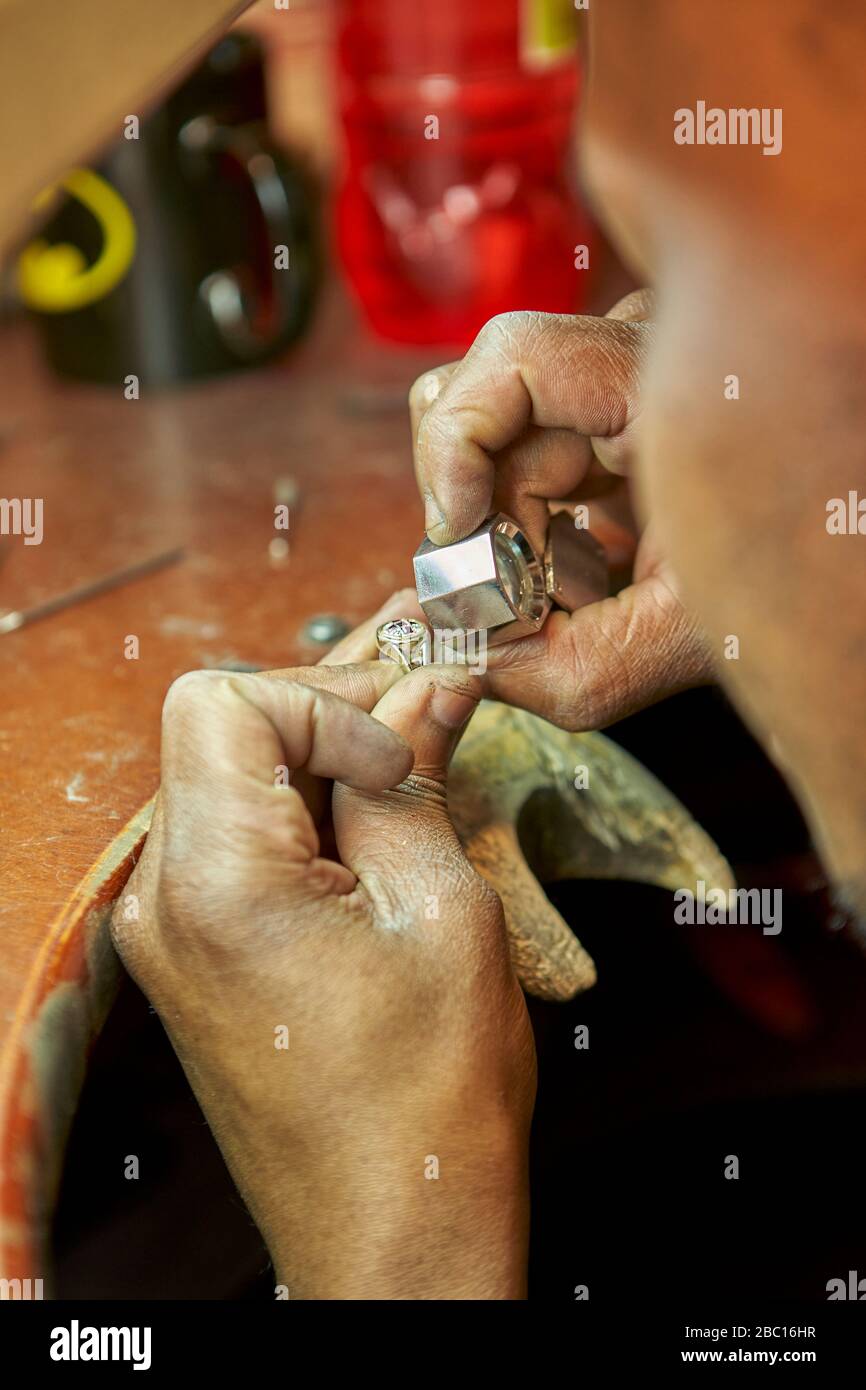 Man repairing a ring with a missing diamond Stock Photo