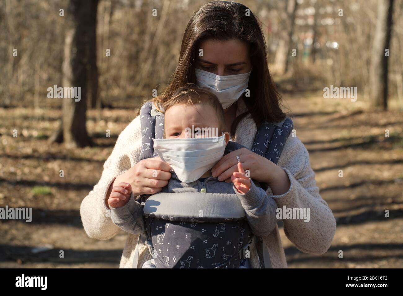 Mother protecting her baby from seasonal virus Stock Photo