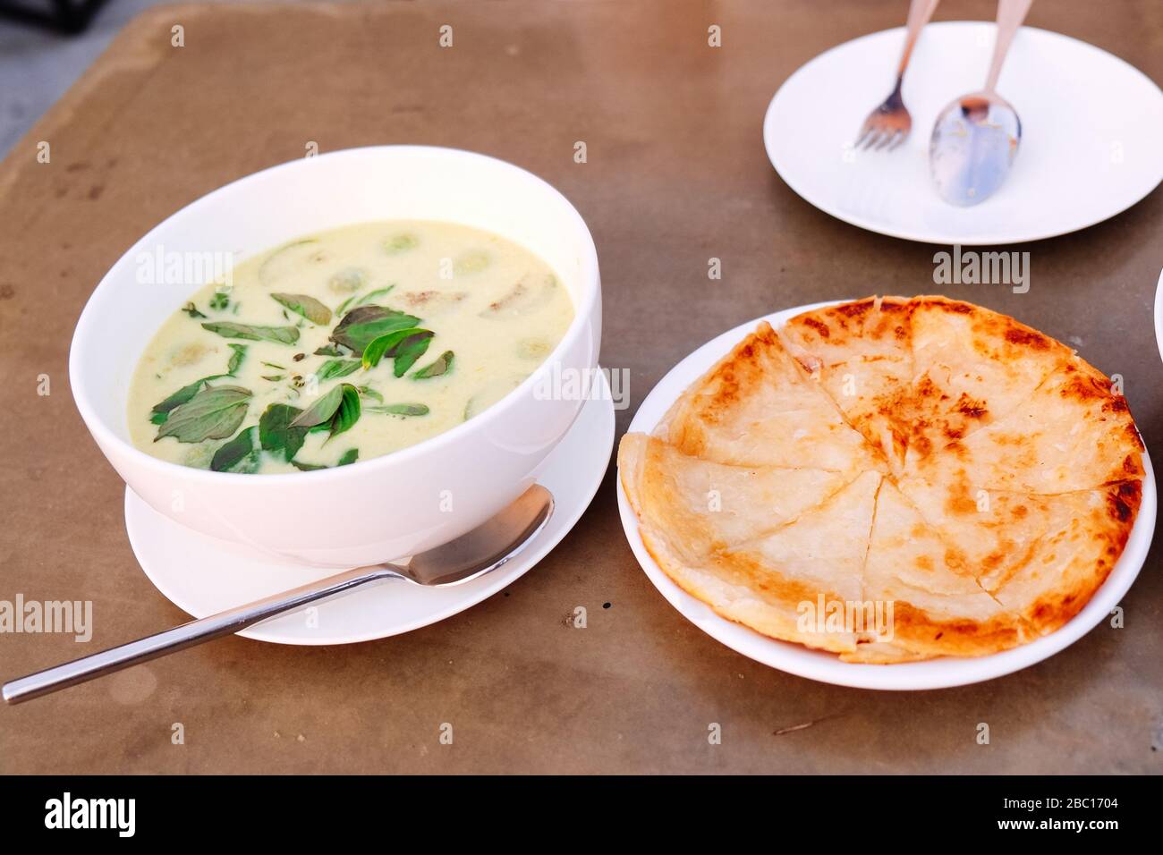 green curry chicken with roti on white dish Stock Photo