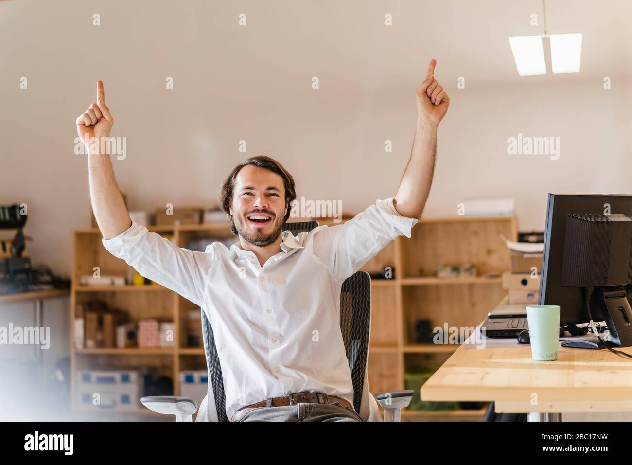 Businessman cheering desk hi-res stock photography and images - Alamy