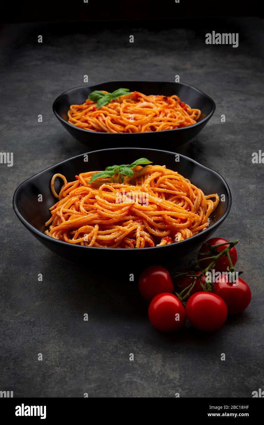 Bowls of spaghetti with basil and Parmesan Stock Photo Alamy