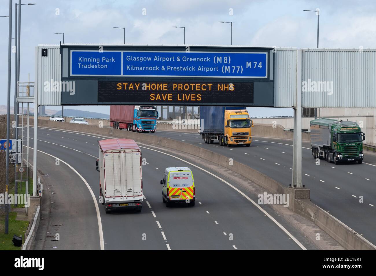 Glasgow, Scotland, UK. 2nd Apr, 2020. Essential vehicles passing under 'Stay Home Protect NHS Save Lives' sign in Glasgow Credit: Kay Roxby/Alamy Live News Stock Photo