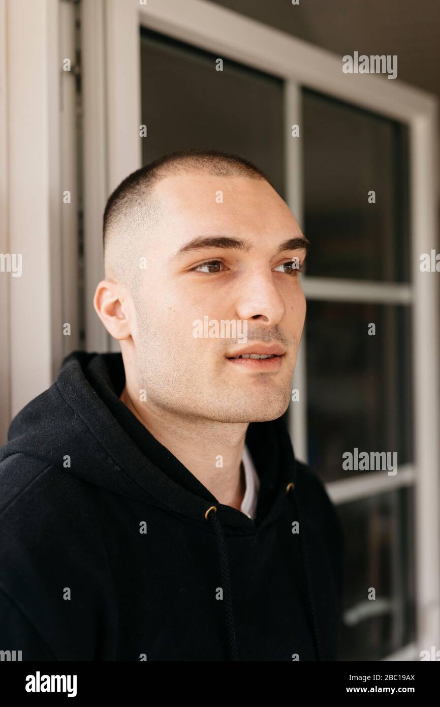 Portrait of pensive young man with shaved head Stock Photo