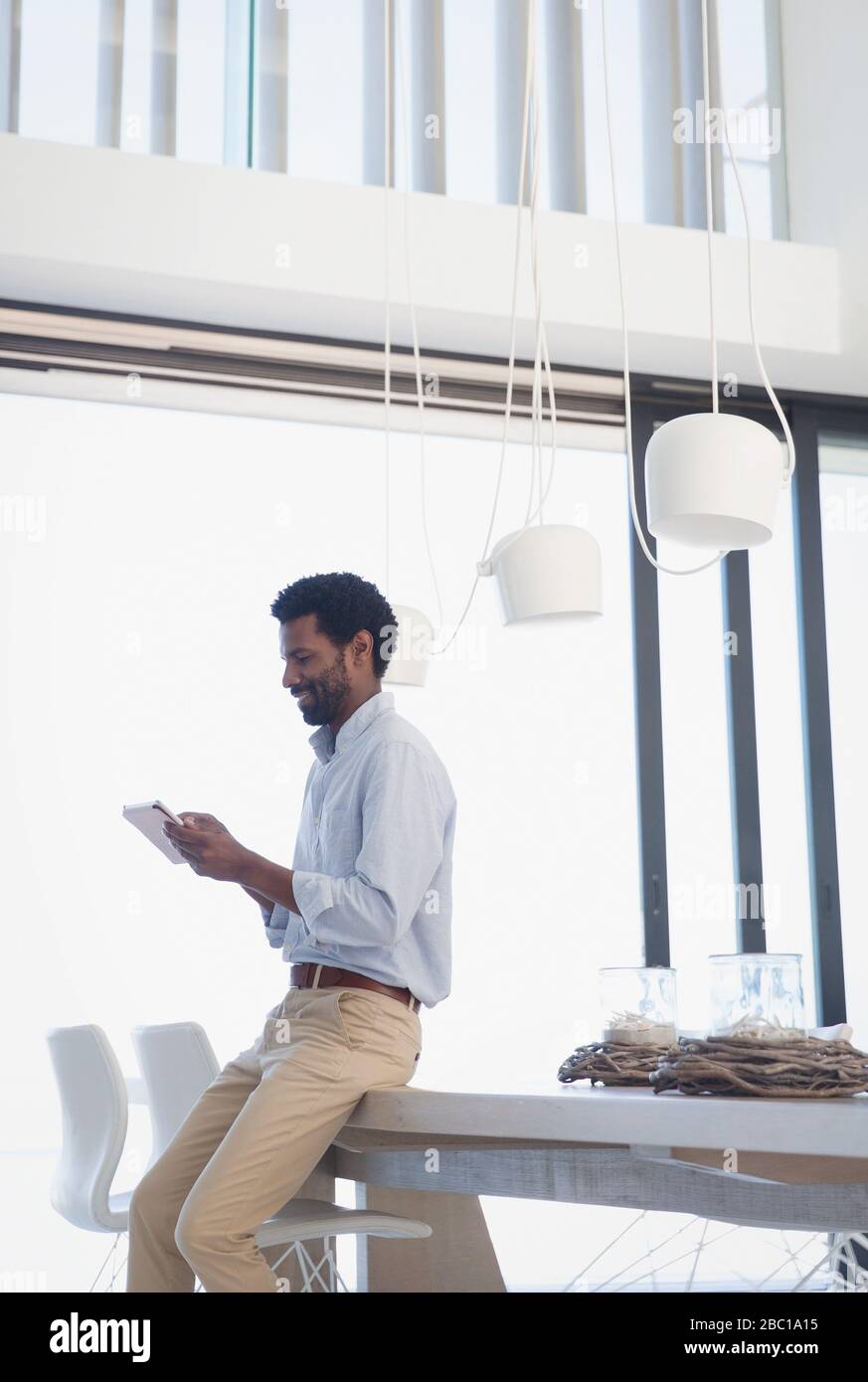 Businessman using digital tablet at dining table Stock Photo