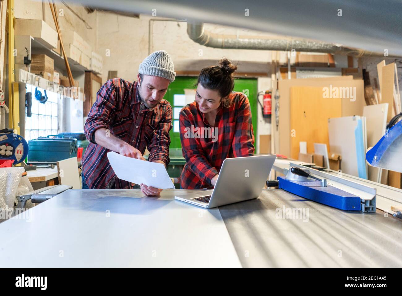 Female craftsman checking plan hi-res stock photography and images - Alamy