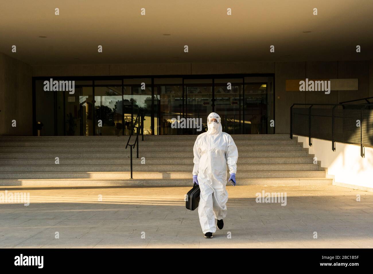 Female scientist wearing protective suit and mask Stock Photo