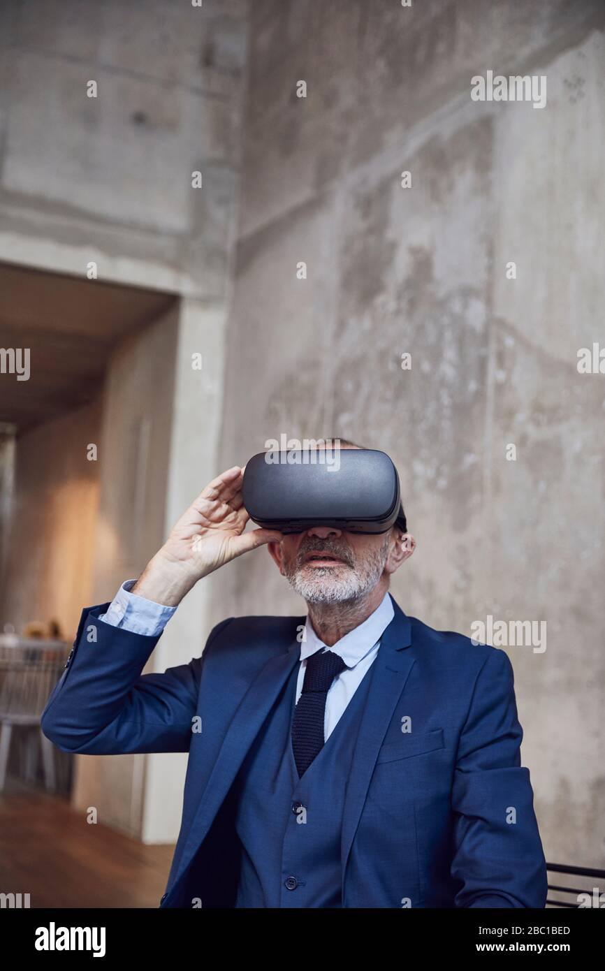 Senior businessman using VR glasses Stock Photo