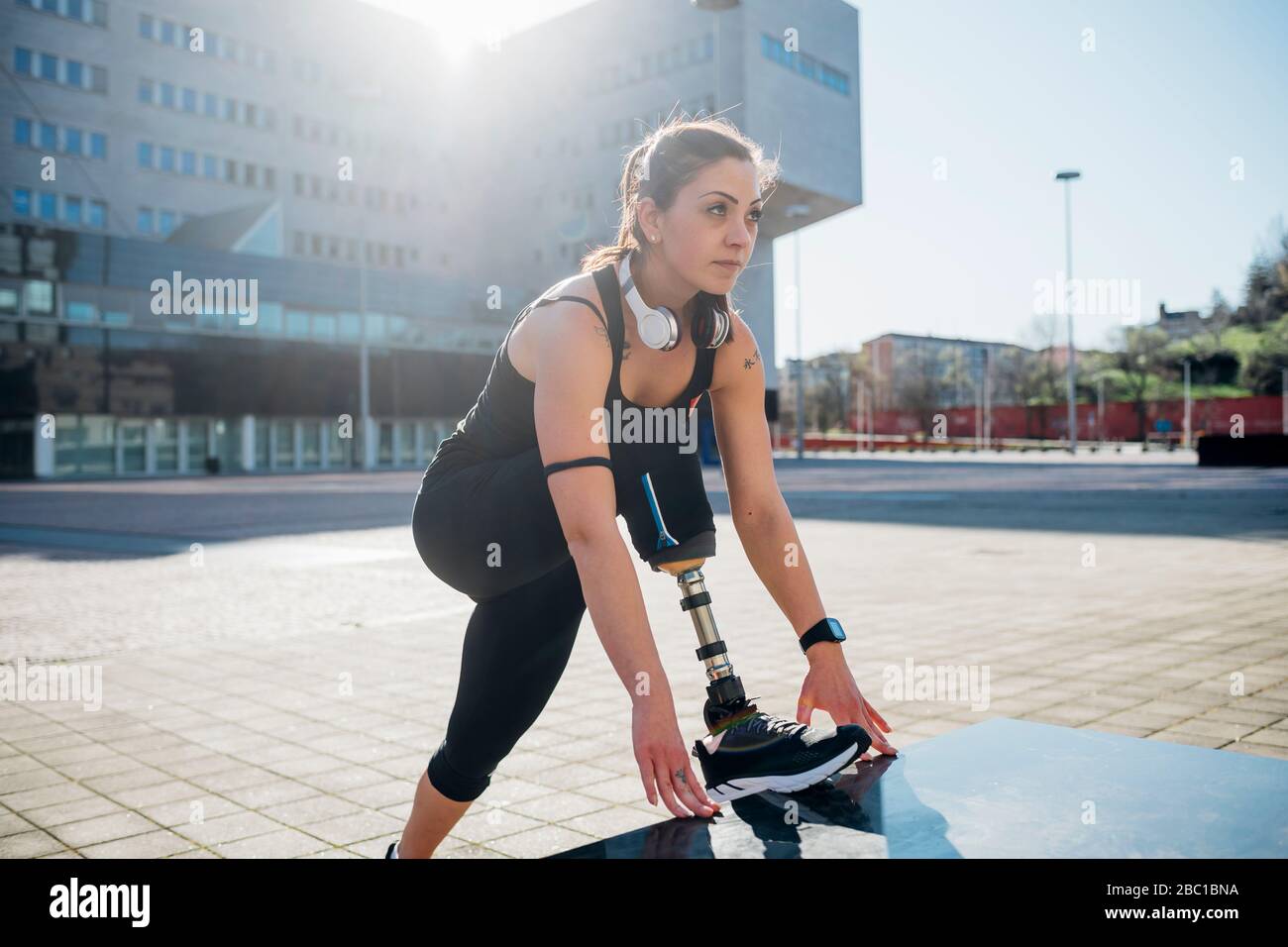 Portrait of sporty young woman with leg prosthesis in the city Stock Photo