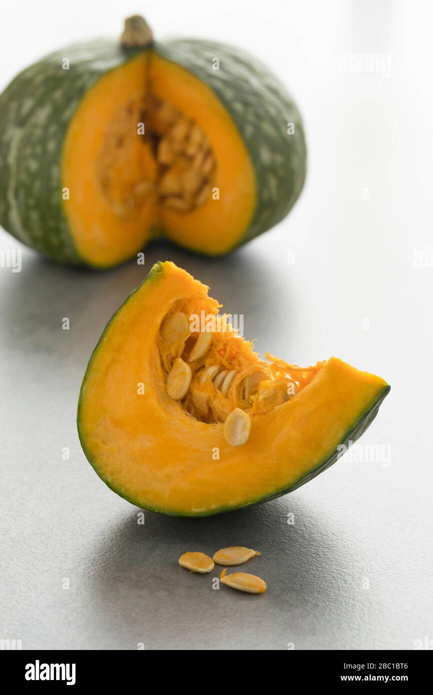 Wedge of a fresh Kabocha winter squash and seeds Stock Photo