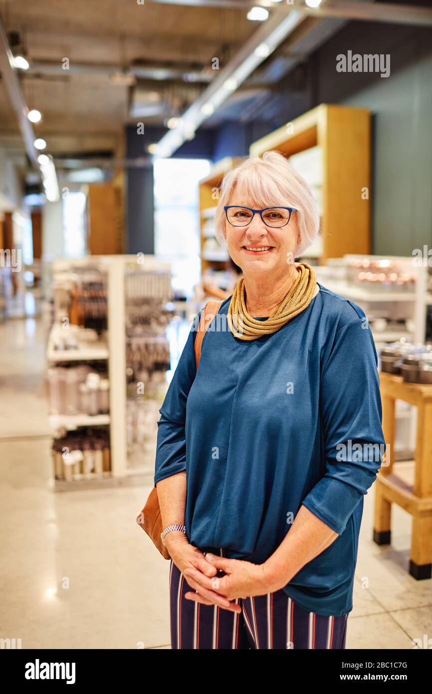 Portrait confident smiling woman in home goods store Stock Photo