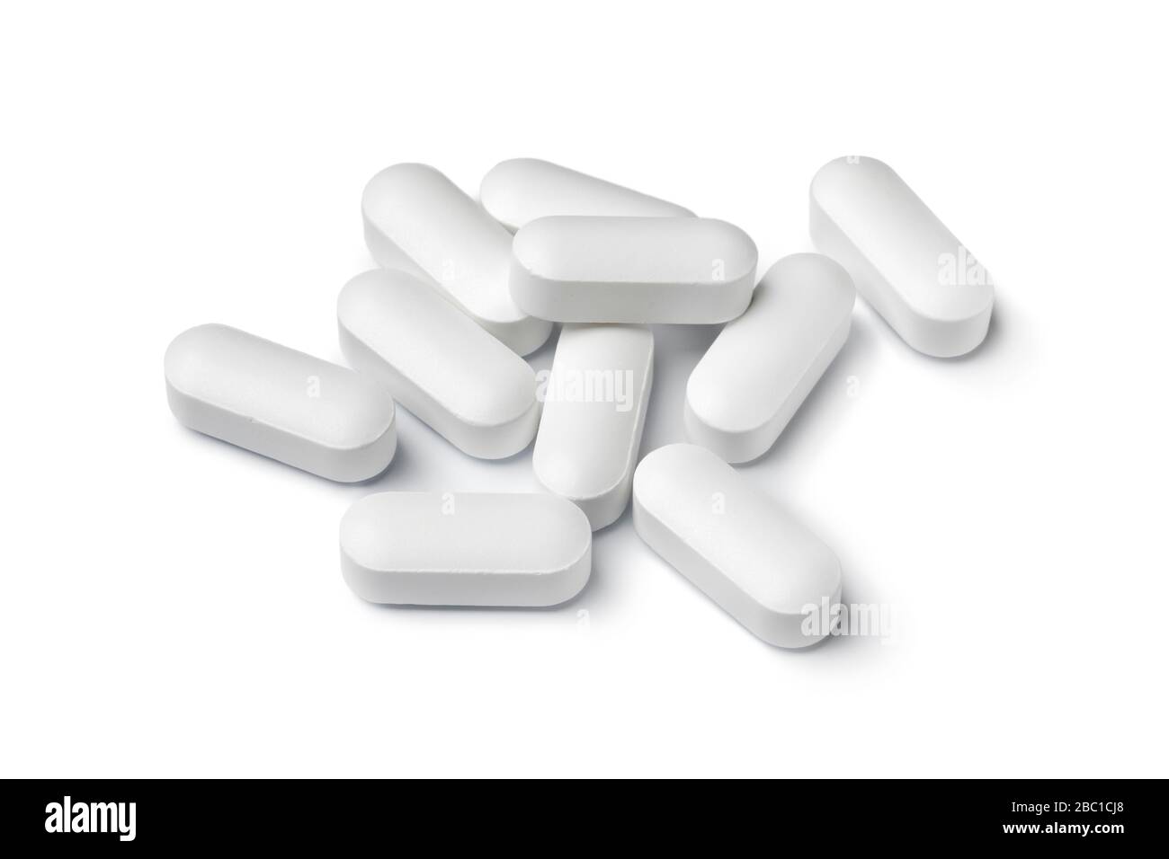 Heap of white medicine tablets isolated on white background Stock Photo