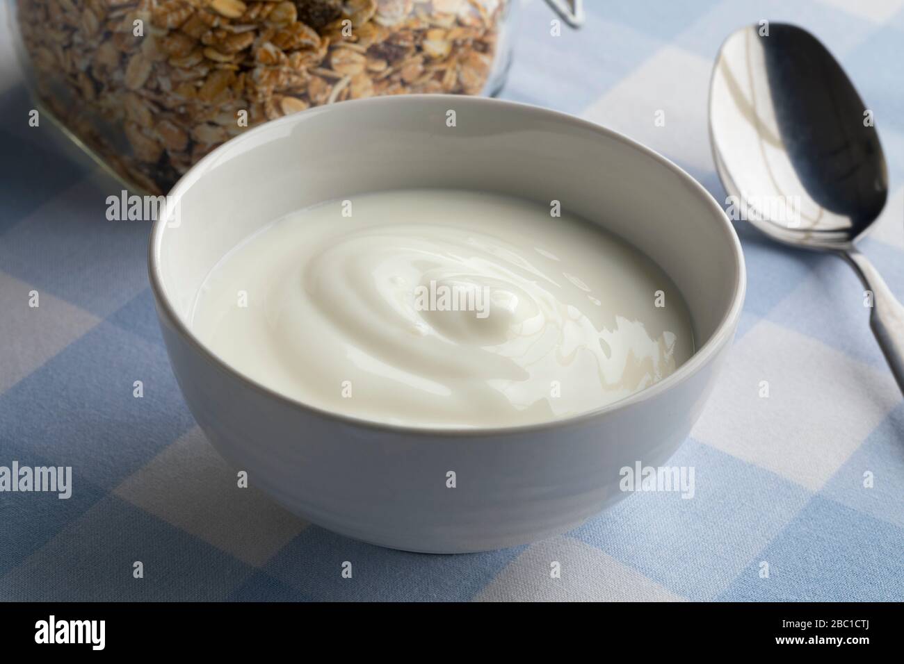 White bowl with yogurt for breakfast Stock Photo
