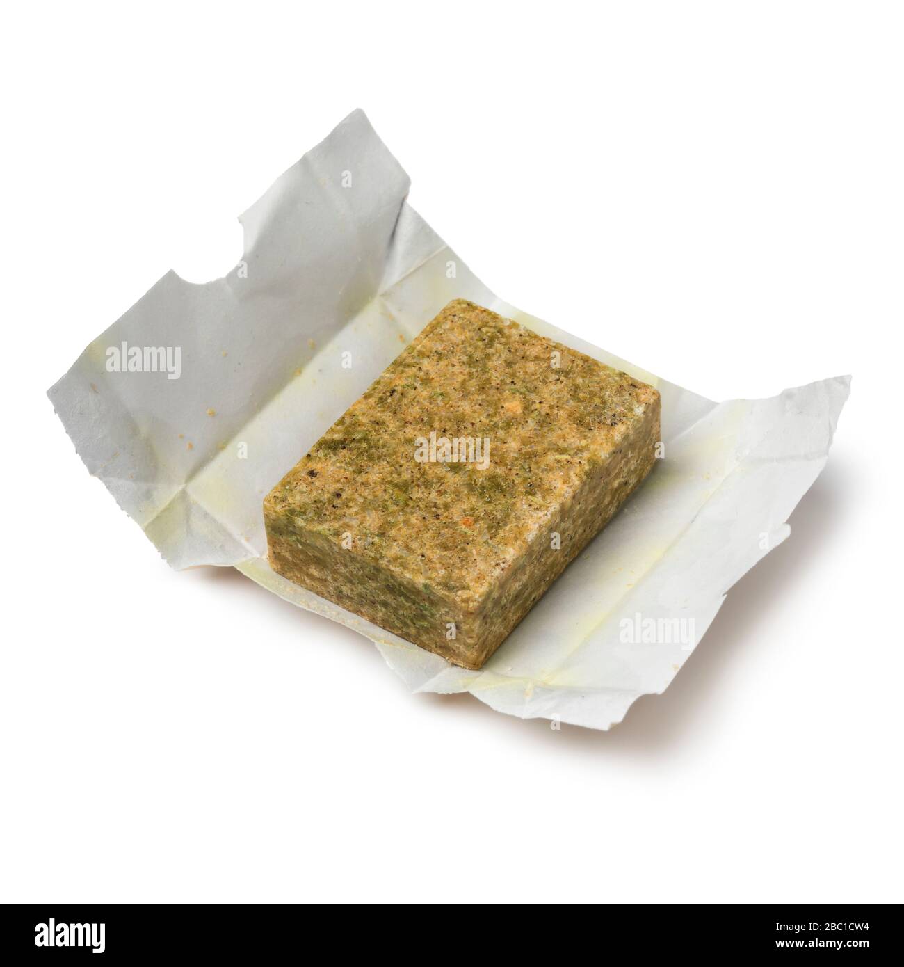 Single vegetarian Bouillon cube on paper isolated on white background Stock Photo