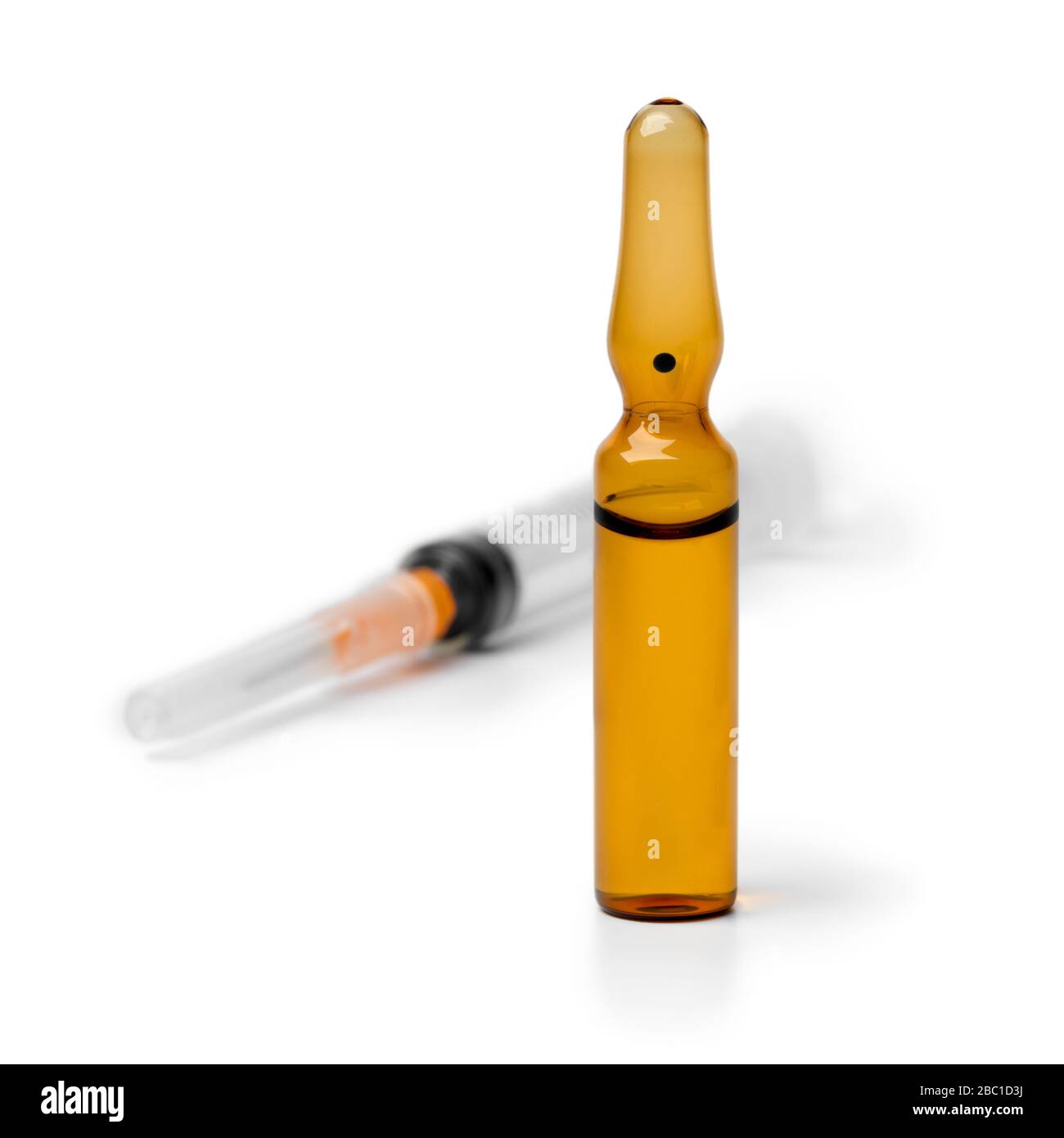 Medical drug ampule and syringe awaiting injection isolated on white