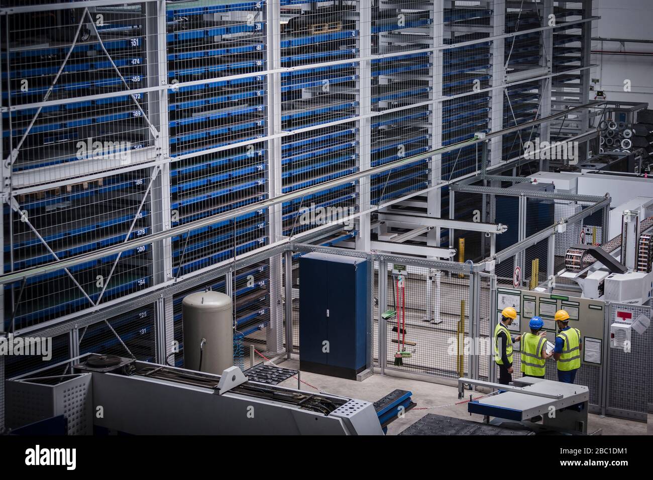 Factory worker discussing data with supervisor in metal factory Stock Photo  - Alamy