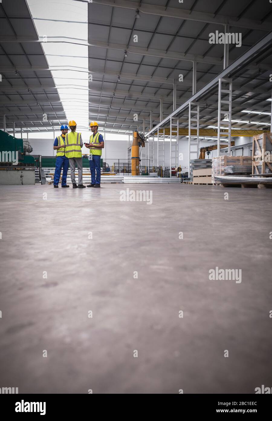 Workers talking in steel factory Stock Photo