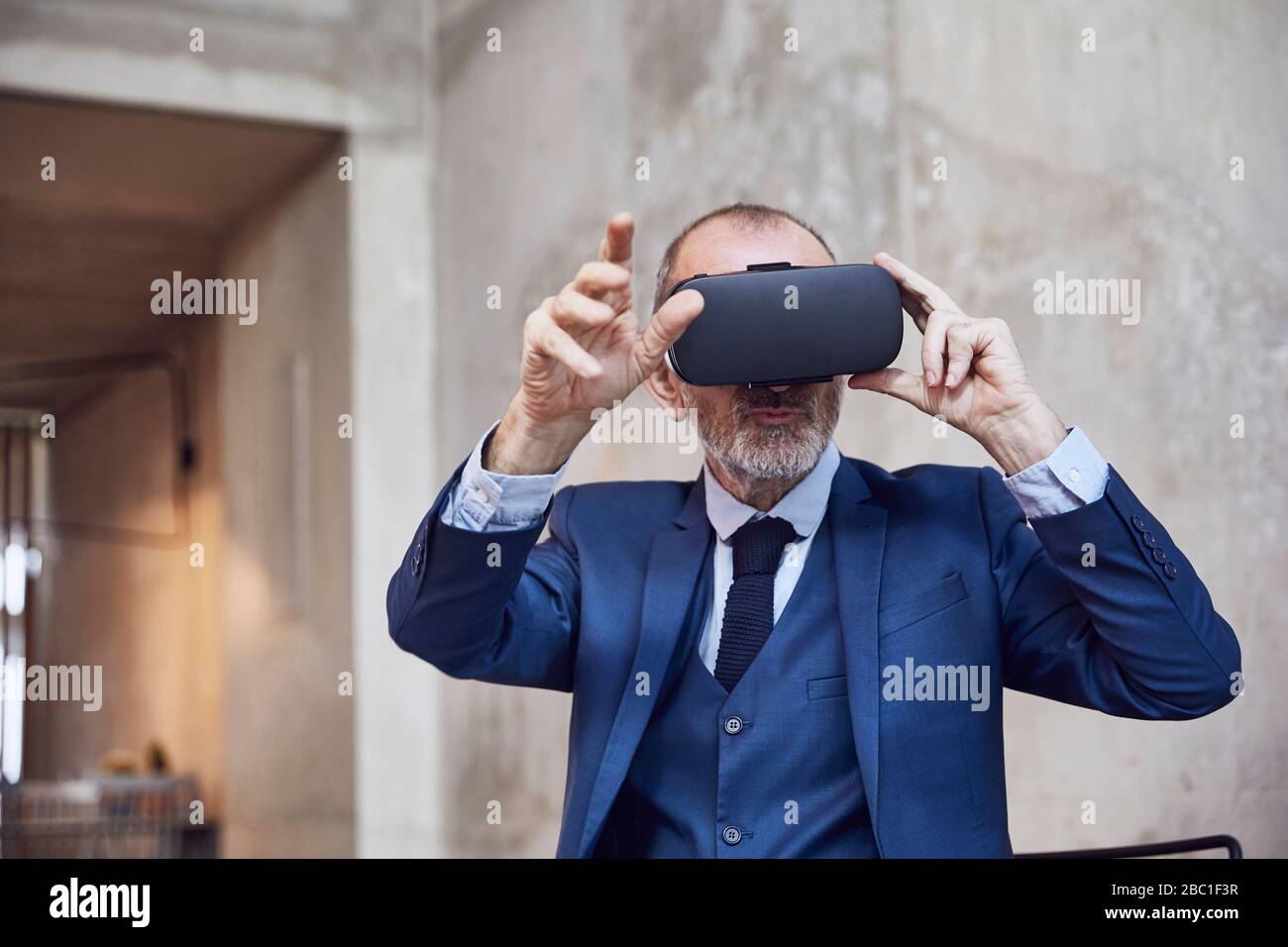 Senior businessman using VR glasses Stock Photo