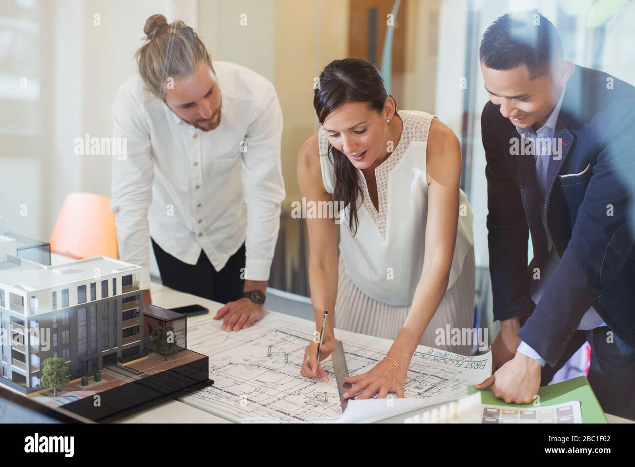 Architects drafting blueprint in office Stock Photo
