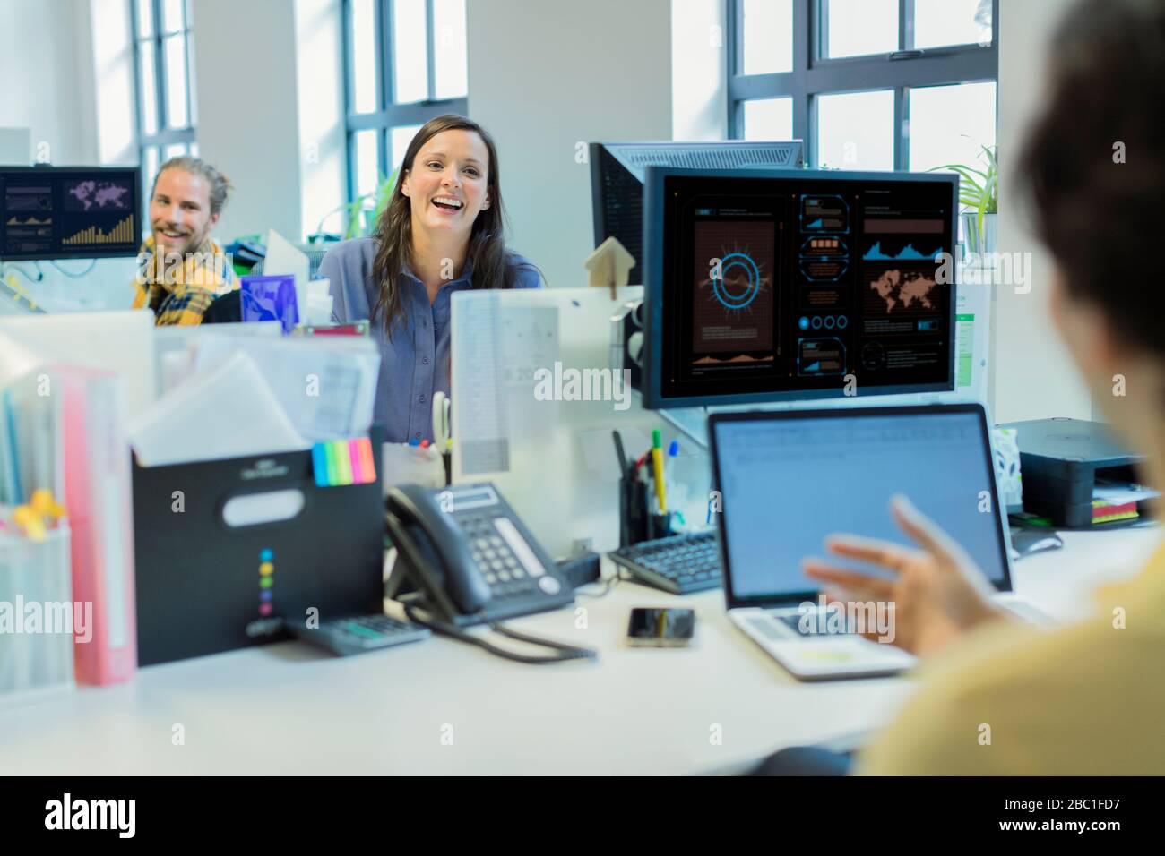 Laughing business people talking in office Stock Photo