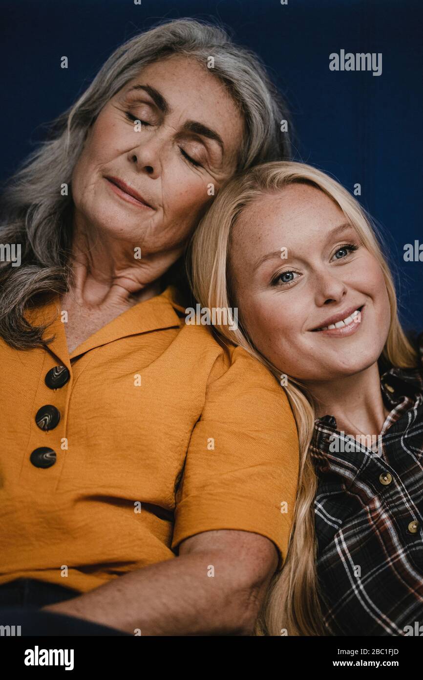 Portrait of smiling mother and adult daughter Stock Photo