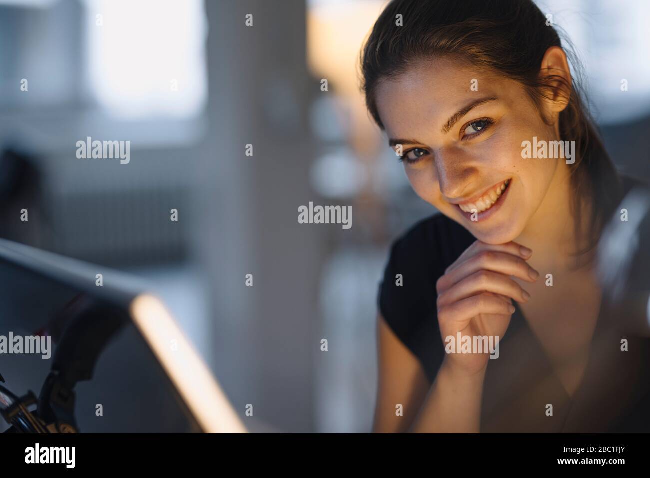 Portrait of happy young businesswoman in office Stock Photo