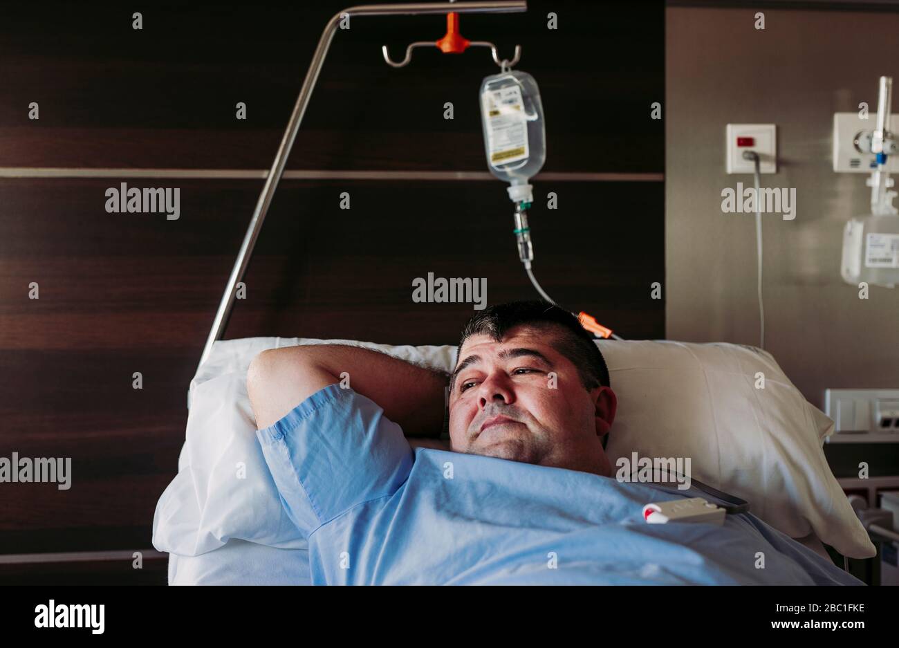 Man lying in hospital bed hi-res stock photography and images - Alamy