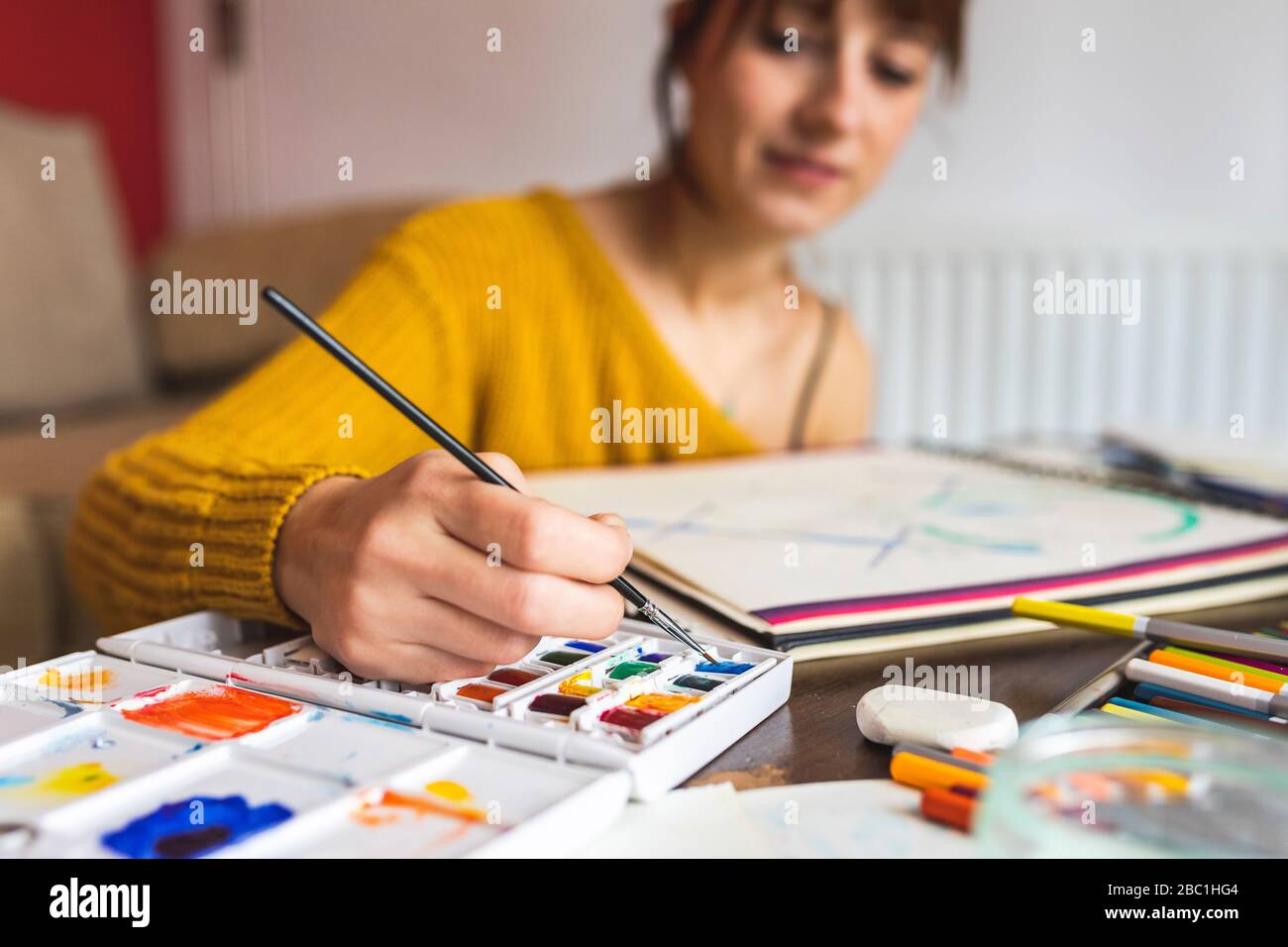 Hand of woman painting with watercolours Stock Photo