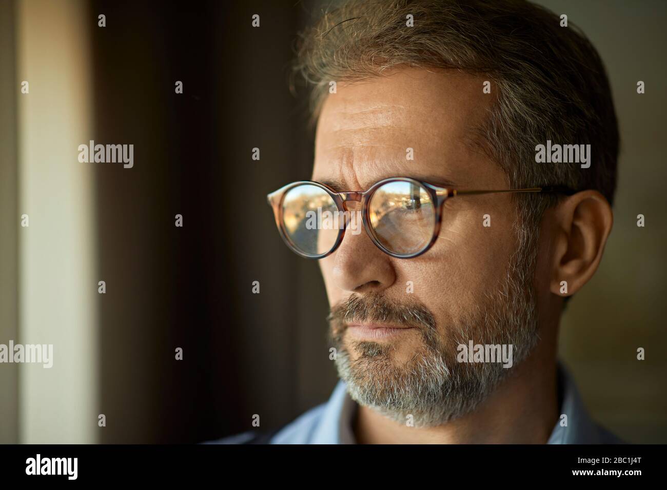 Man wearing glasses with serious face hi-res stock photography and ...