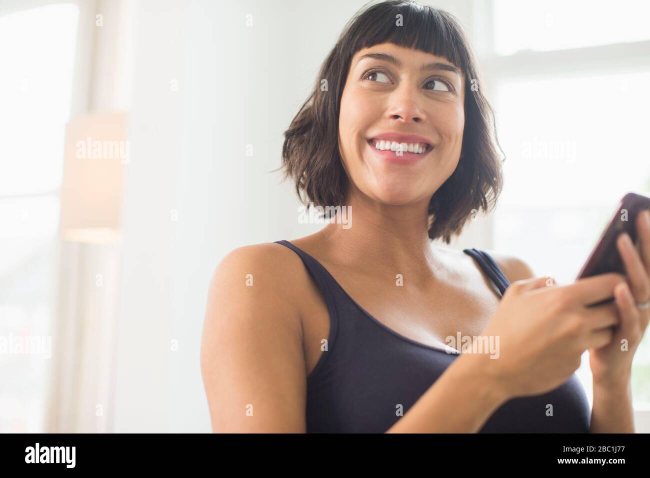 Happy beautiful woman using smart phone Stock Photo