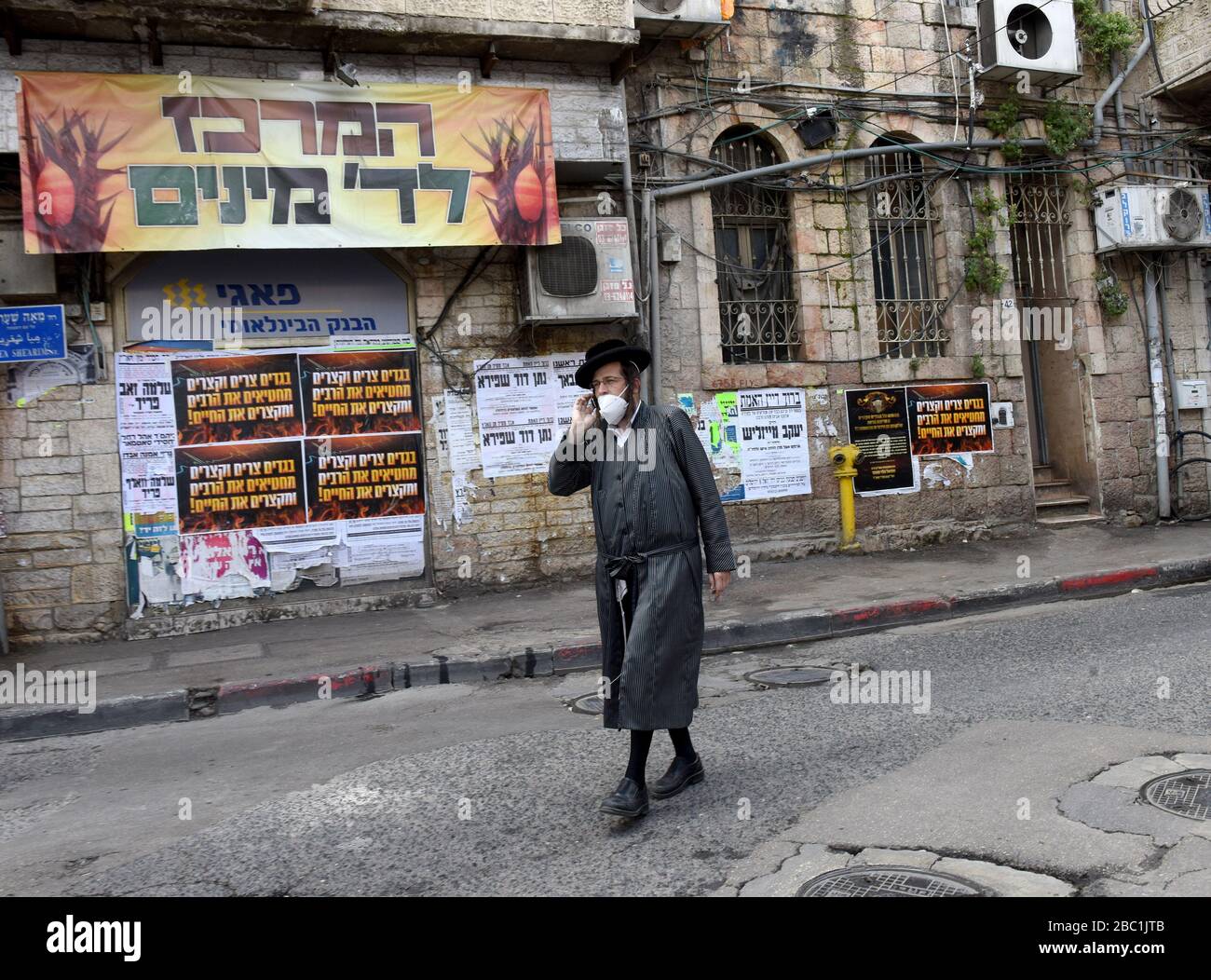 Jerusalem, Israel. 02nd Apr, 2020. An Ultra-Orthodox Jew wears a protective mask, against the coronavirus, in the Mea Shearim neighborhood in Jerusalem, on Thursday, April. 2, 2020. The cases of coronavirus has jumped in Israeli Ultra-Orthodox cities, amid growing concerns of a major outbreak of COVID-19 in the religious communities. Photo by Debbie Hill/UPI Credit: UPI/Alamy Live News Stock Photo
