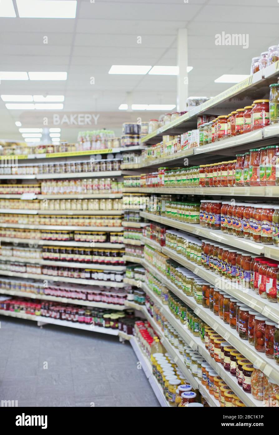 Jars of food lining supermarket shelves Stock Photo