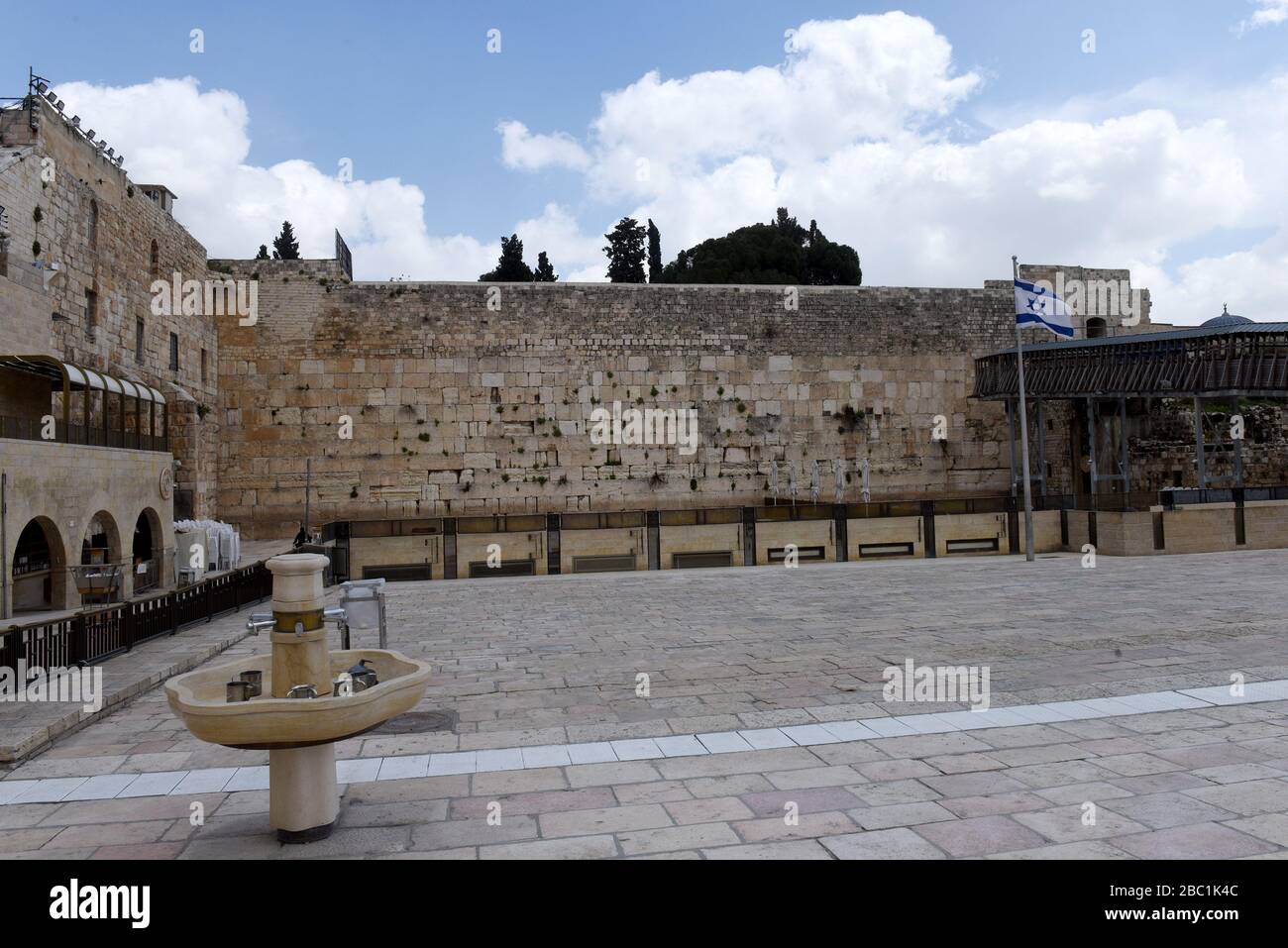 Old City Jerusalem, Israel. 02nd Apr, 2020. An Israeli flag flies in the empty plaza at the Western Wall, Judaism's holiest site, in the Old City of Jerusalem, on Thursday, April. 2, 2020. The cases of coronavirus has jumped in Israeli Ultra-Orthodox cities, amid growing concerns of a major outbreak of COVID-19 in the religious communities. Photo by Debbie Hill/UPI Credit: UPI/Alamy Live News Stock Photo