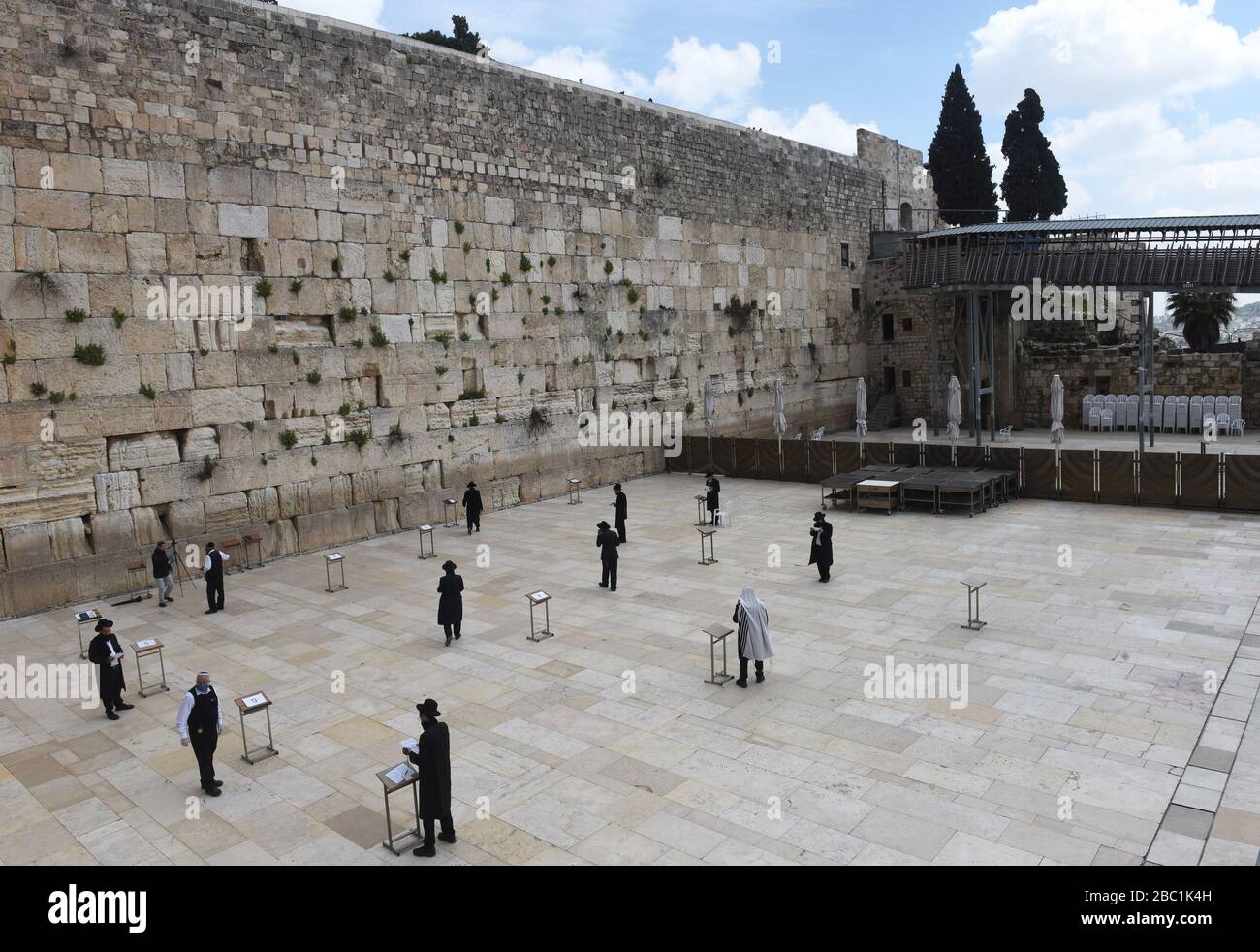 Old City Jerusalem, Israel. 02nd Apr, 2020. Ultra-Orthodox Jews pray separated by distance, because of the coronavirus, at the Western Wall, Judaism's holiest site, in the Old City of Jerusalem, on Thursday, April. 2, 2020. The cases of coronavirus has jumped in Israeli Ultra-Orthodox cities, amid growing concerns of a major outbreak of COVID-19 in the religious communities. Photo by Debbie Hill/UPI Credit: UPI/Alamy Live News Stock Photo