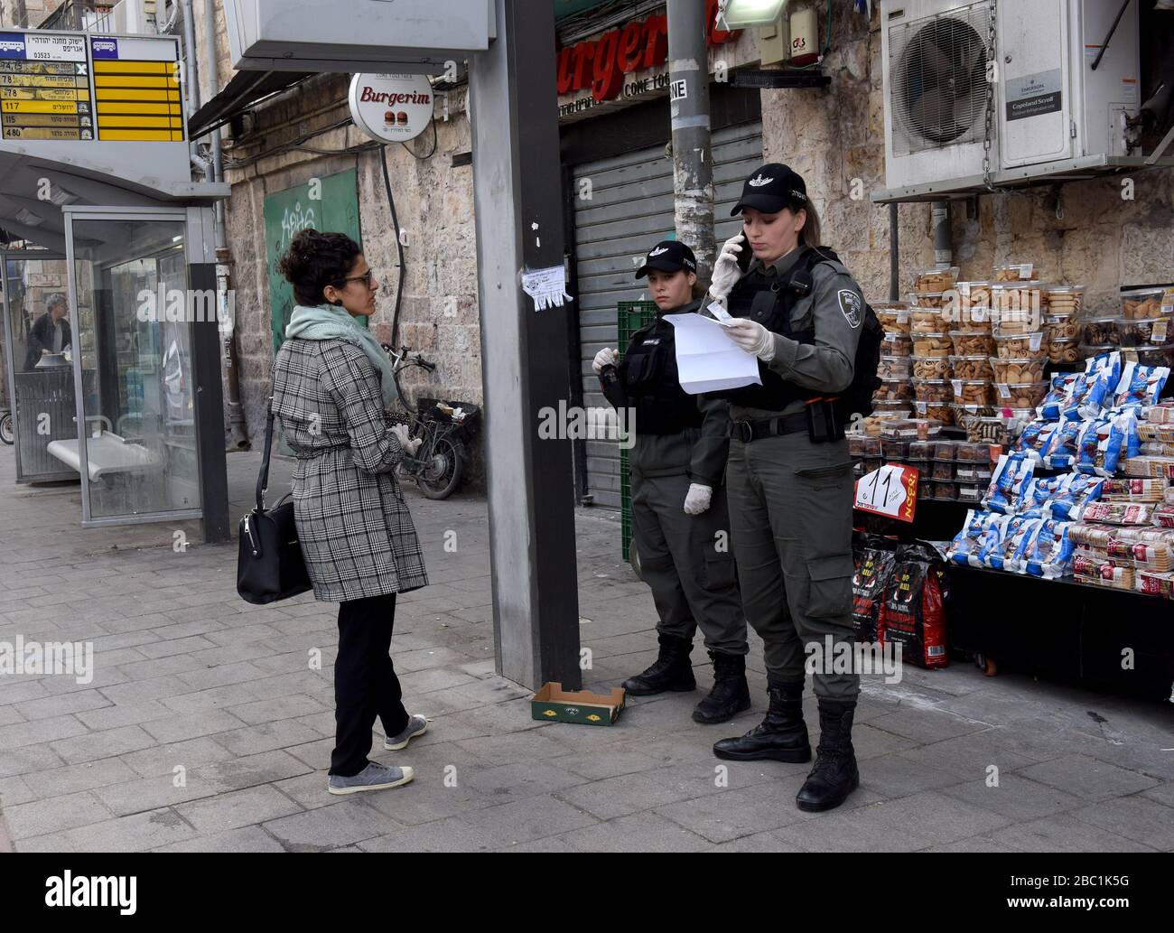 Jerusalem, Israel. 02nd Apr, 2020. Israeli border police check a woman's papers for movement restrictions, because of the coronavirus, Jerusalem, on Thursday, April. 2, 2020. The cases of coronavirus has jumped in Israeli Ultra-Orthodox cities, amid growing concerns of a major outbreak of COVID-19 in the religious communities. Photo by Debbie Hill/UPI Credit: UPI/Alamy Live News Stock Photo