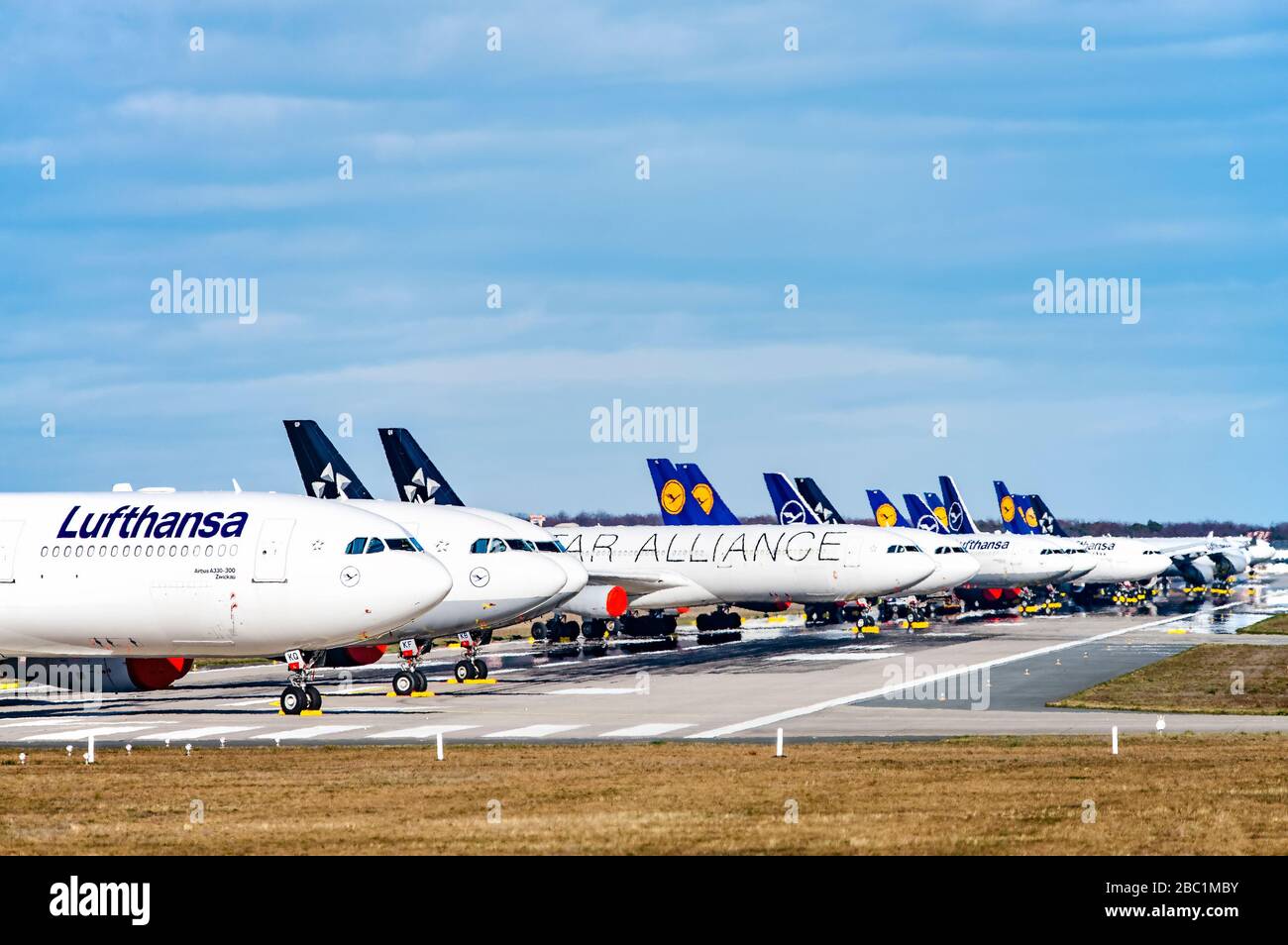 Frankfurt, Hessen/Germany - March 30 2020Lufthansa aircraft (Airbus A330 and 340) are parked on the north-west runway of Frankfurt Airport as a result Stock Photo