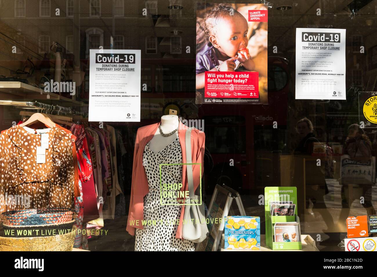 Signs about Covid 19 in the window of a closed Oxfam charity shop during the coronavirus outbreak. Uxbridge Road, Ealing, London Stock Photo