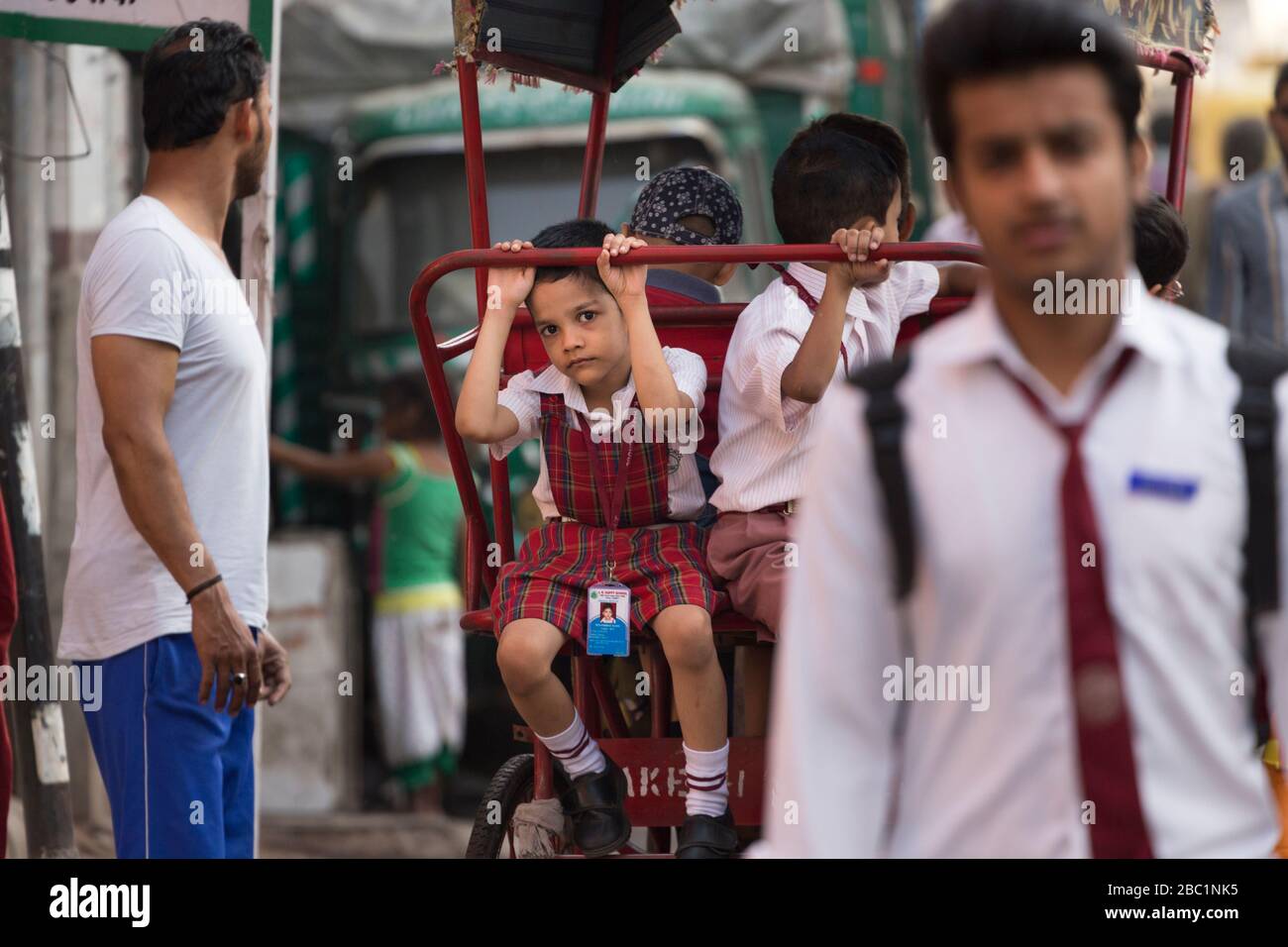 Portrait of a schoolchild on a cycle rickshaw in Delhi, India Stock Photo