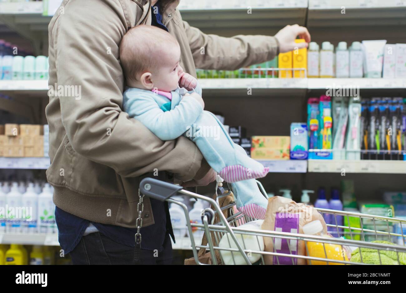 Father with baby shopping in supermarket Stock Photo