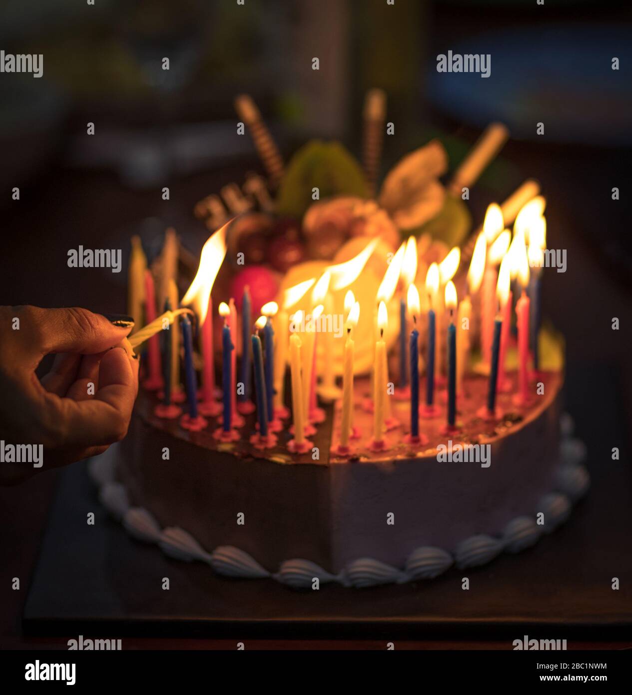 Birthday cake with candles in dark Stock Photo