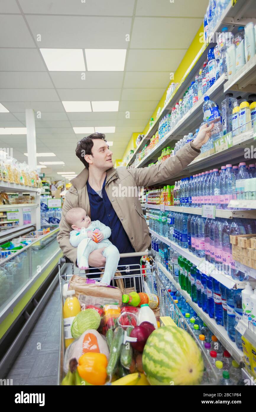Father with baby shopping in supermarket Stock Photo