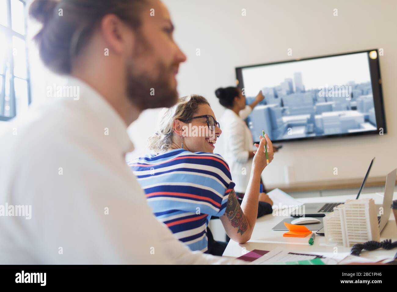 Smiling female architect talking in conference room meeting Stock Photo