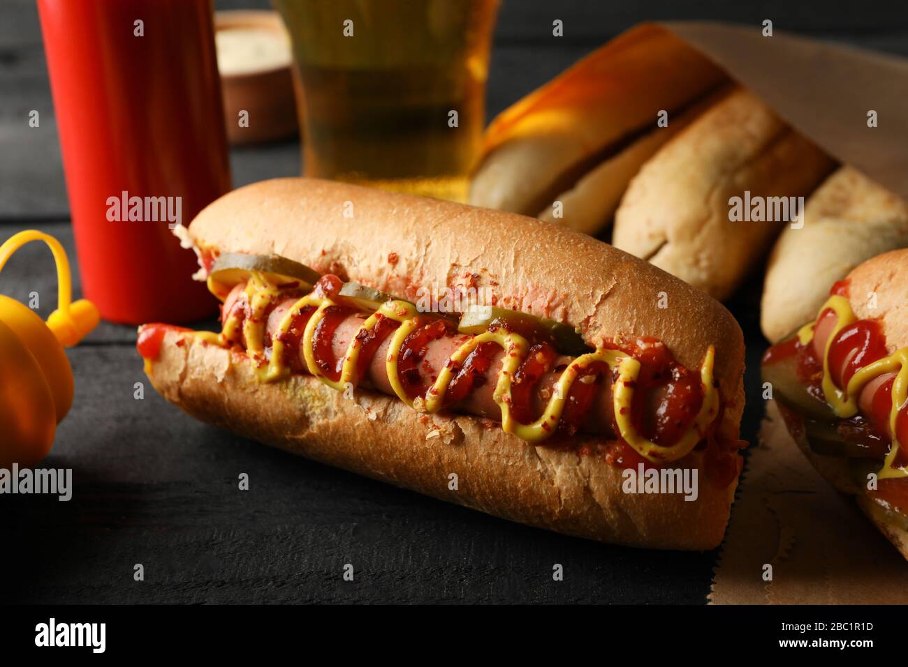 Composition with tasty hot dogs on wooden background Stock Photo