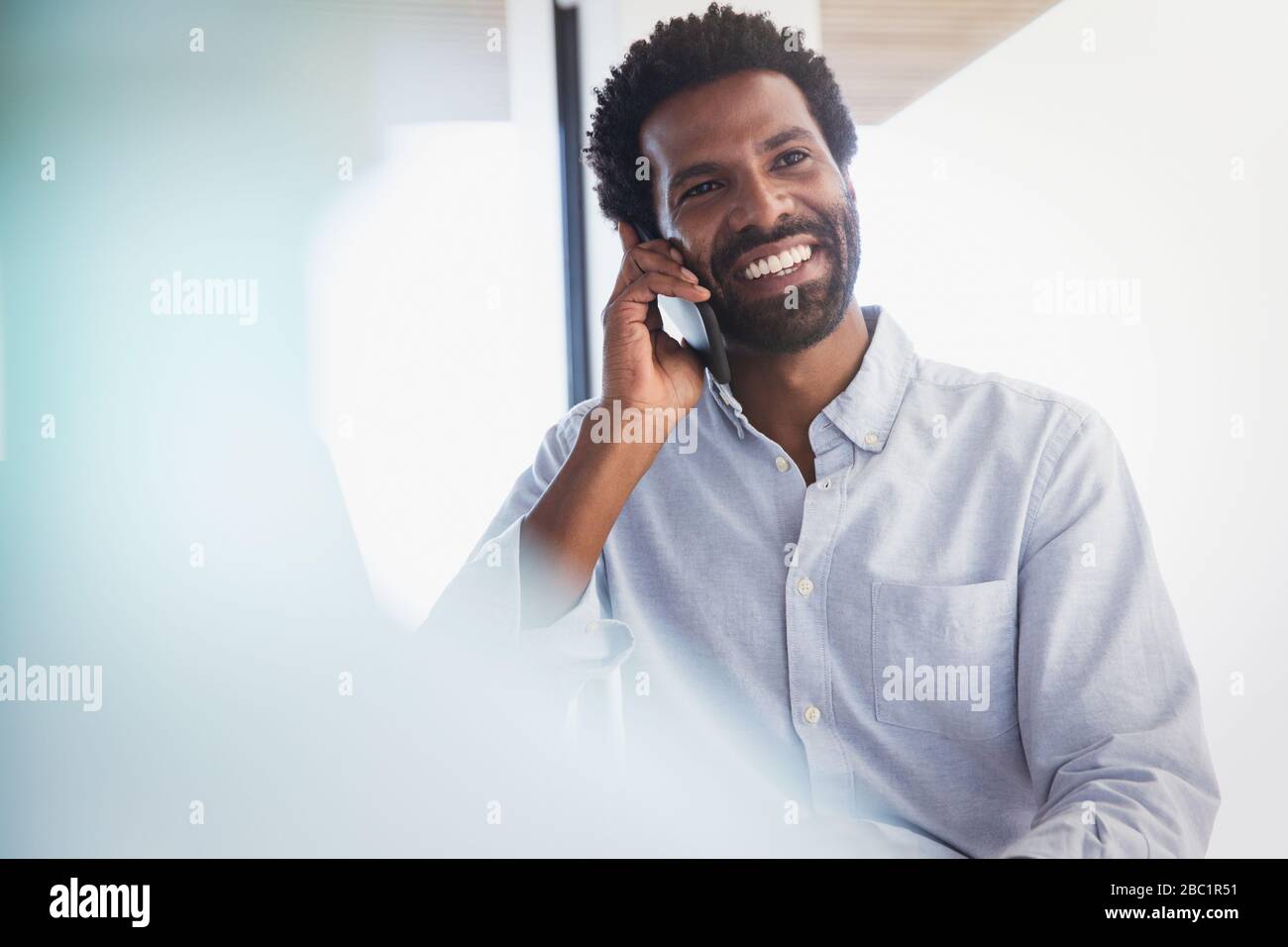 Smiling businessman talking on cell phone Stock Photo