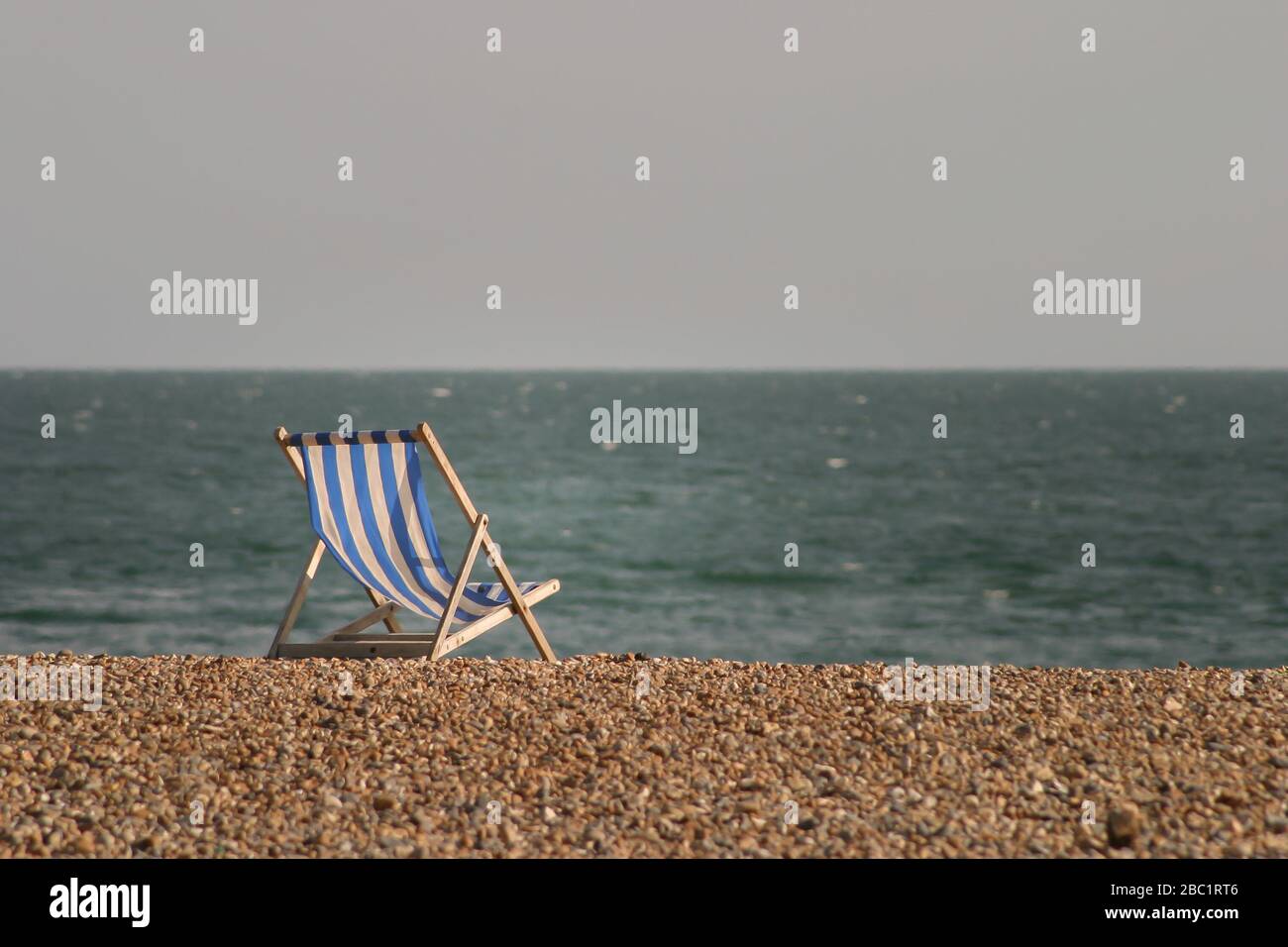 lonelt deck chair on Brighton beach Stock Photo Alamy