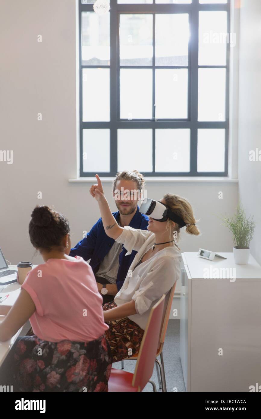 Computer programmers testing virtual reality simulator glasses in office Stock Photo