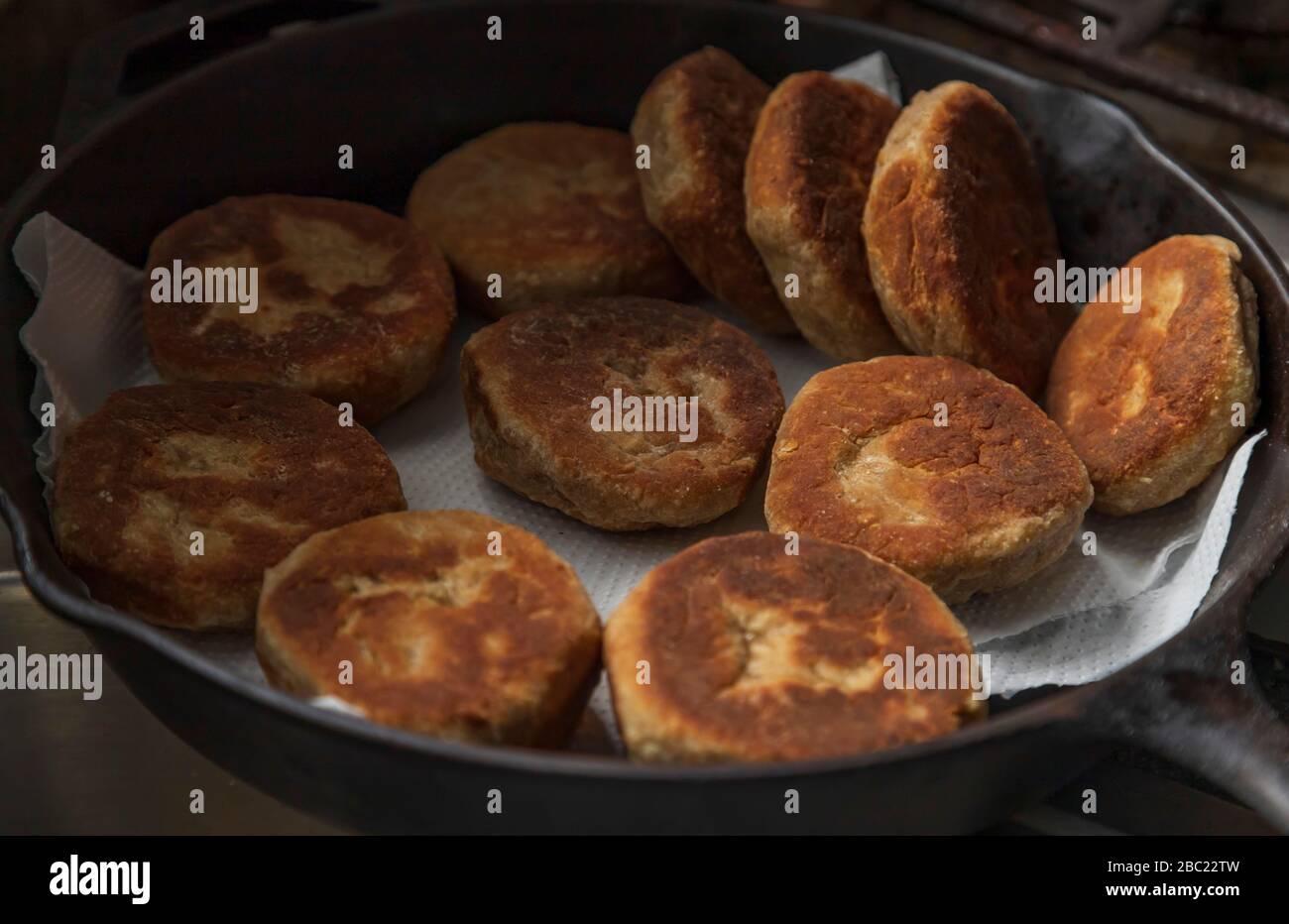 Fried in coconut oil, stove top golden brown whole wheat flour and oatmeal bakes in a pan, popular West Indian tasty delicious healthy breakfast food Stock Photo