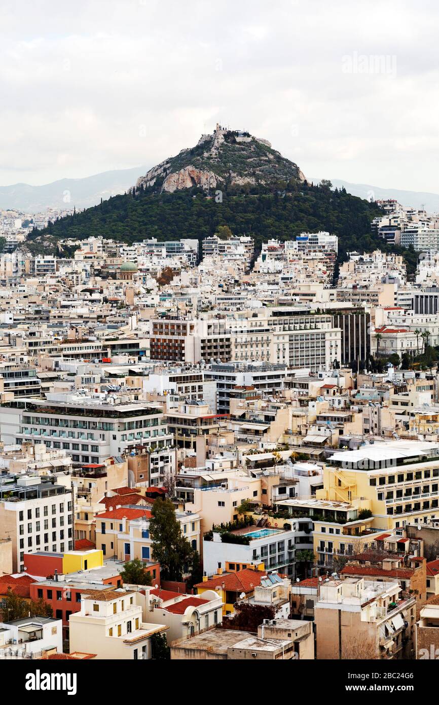 Mount Lycabettus rises above buildings in central Athens, Greece. The Chapel of St George tops the hill. Stock Photo